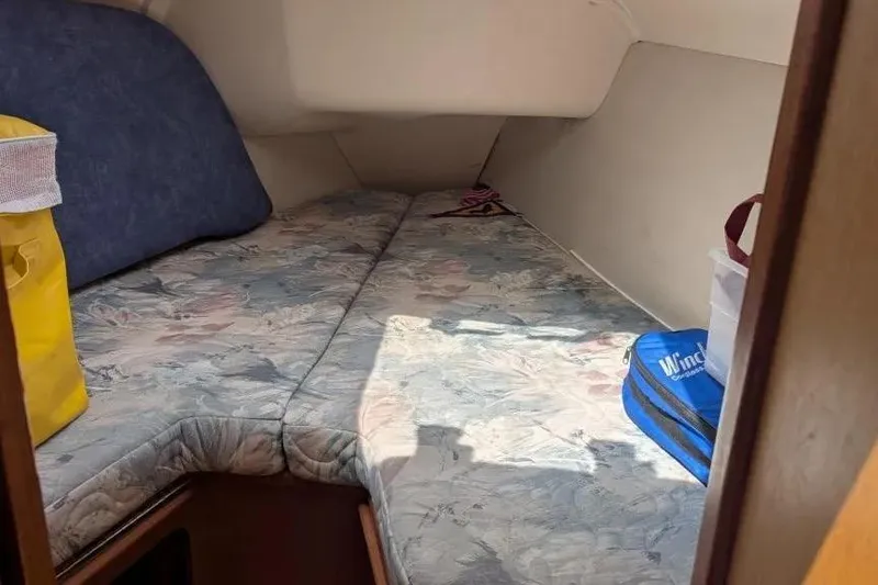 Slide: The Image of Interior cabin of a 1998 Hunter 34 sailboat with floral-patterned cushions. - 12