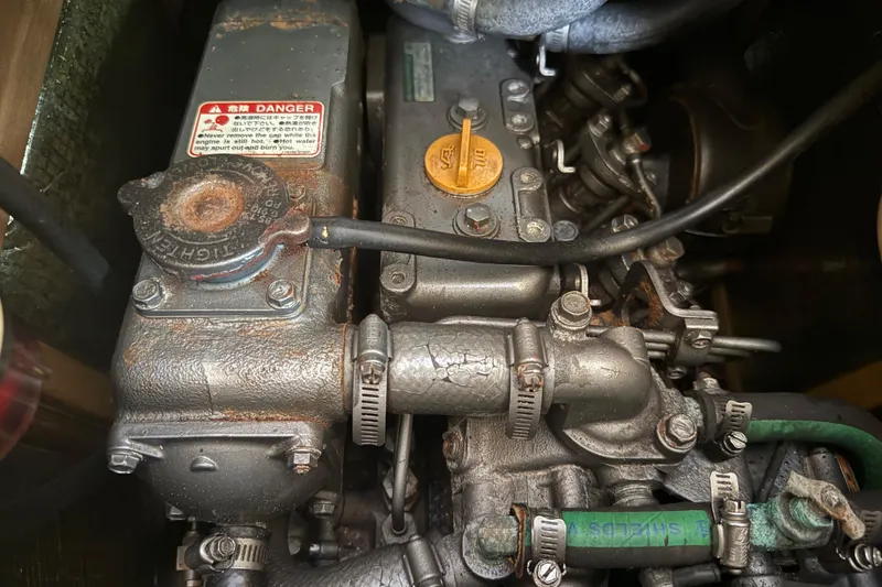 Slide: The Image of Engine compartment of a 1998 Hunter 34 sailboat, showing detailed mechanical components. - 20