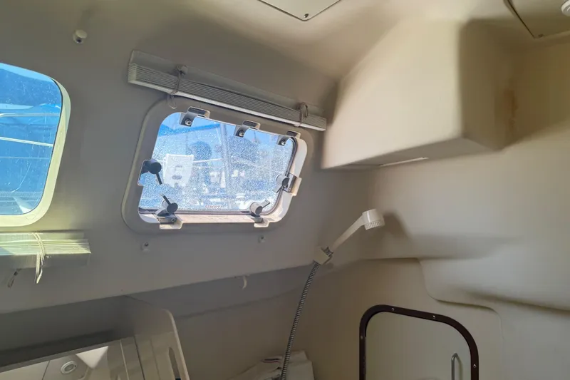 Slide: The Image of Interior of a 1998 Hunter 34 sailboat, featuring a window and cabin details. - 21