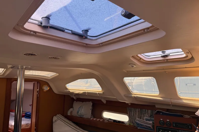 Slide: The Image of Interior of a 1998 Hunter 34 sailboat with skylights and cozy cabin features. - 22