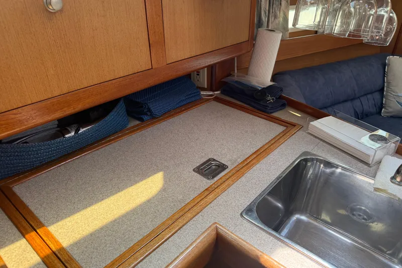 Slide: The Image of Interior of a 1998 Hunter 34 sailboat galley with sink and storage. - 23