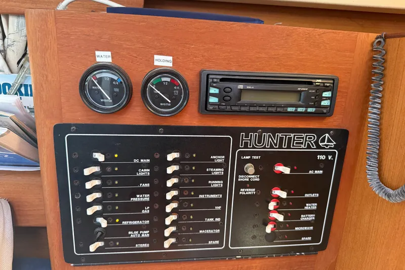 Slide: The Image of Control panel of a 1998 Hunter 34 sailboat with gauges and switches. - 25