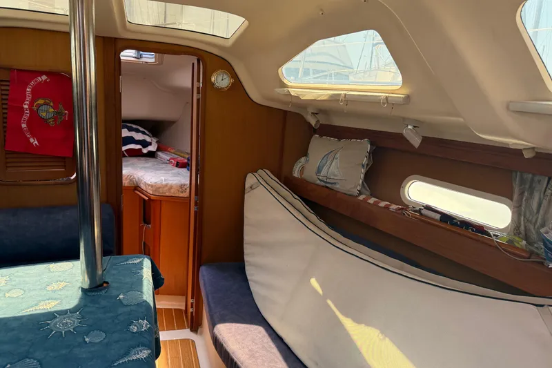 Slide: The Image of Interior of a 1998 Hunter 34 sailboat with cozy seating and nautical decor. - 26