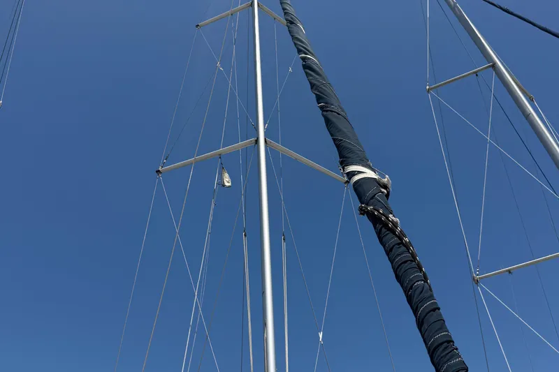 Slide: The Image of Masts and rigging of a 1998 Hunter 34 sailboat against a clear blue sky. - 6