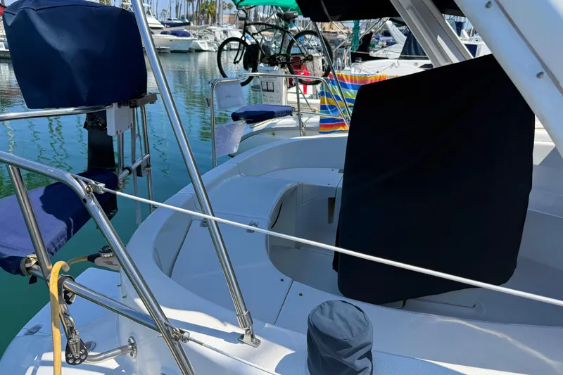 Slide: The Image of 1998 Hunter 34 sailboat cockpit with blue covers, docked in a marina. - 8