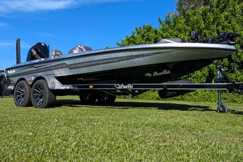 Slide: The Image of 2026 Bass Cat Cougar FTD SP boat on trailer, parked on grass. - 1