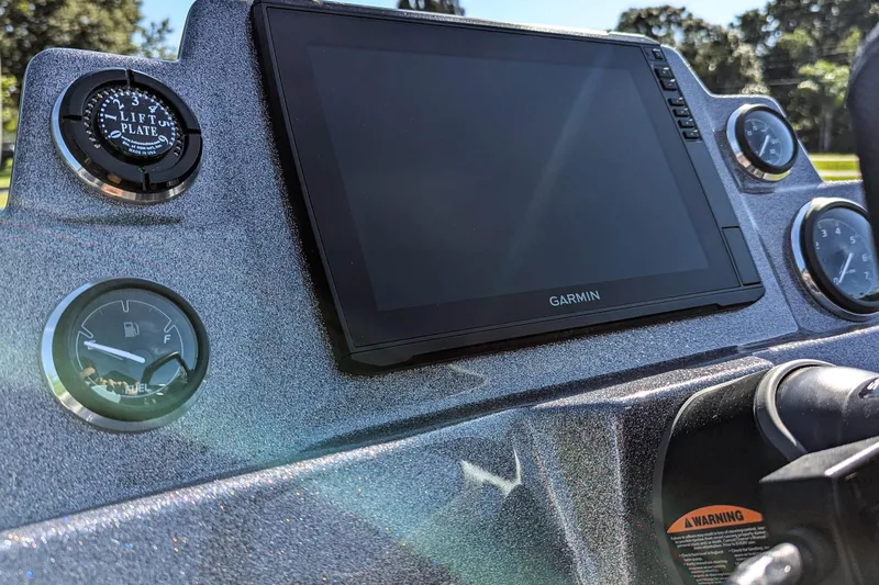 Slide: The Image of 2026 Bass Cat Cougar FTD SP dashboard with Garmin display and gauges. - 12