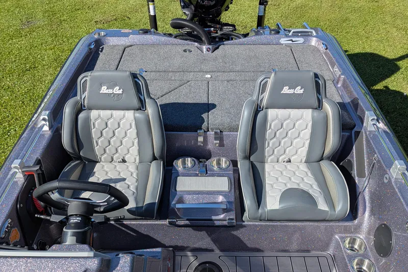 Slide: The Image of 2026 Bass Cat Cougar FTD SP boat interior with dual seats and steering wheel. - 13