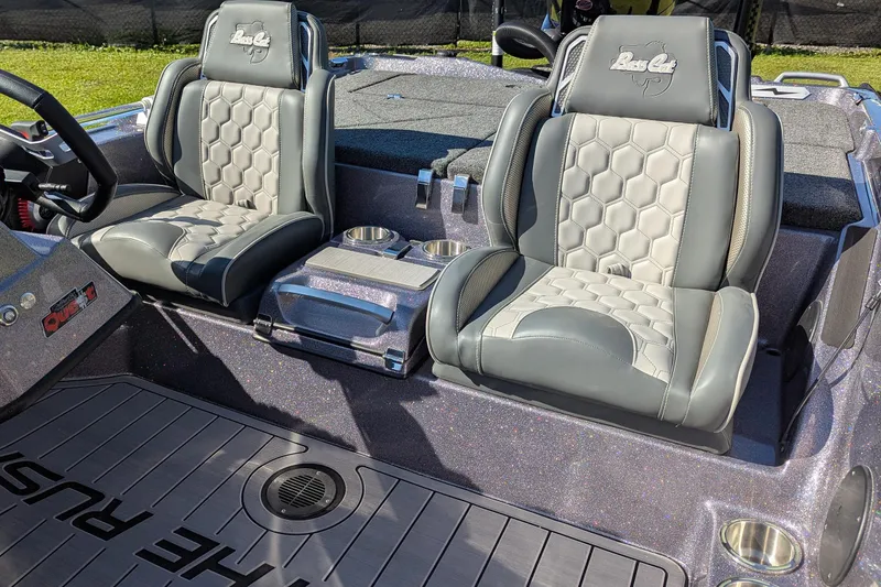 Slide: The Image of 2026 Bass Cat Cougar FTD SP boat seats with hexagonal pattern and cup holders. - 14