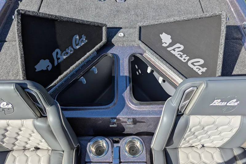 Slide: The Image of 2026 Bass Cat Cougar FTD SP boat interior with storage compartments and branded seats. - 15