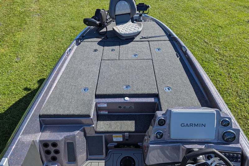 Slide: The Image of 2026 Bass Cat Cougar FTD SP boat with Garmin system on grassy background. - 8
