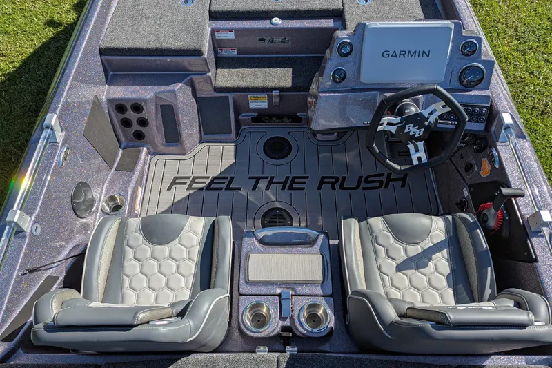 Slide: The Image of 2026 Bass Cat Cougar FTD SP boat interior with Garmin system and "Feel the Rush" flooring. - 9