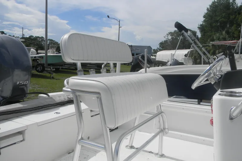 Slide: The Image of 2016 Frontier 2104 boat interior with white seating and steering wheel. - 4
