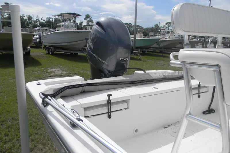 Slide: The Image of 2016 Frontier 2104 boat with Yamaha 150 outboard motor in a marina setting. - 5