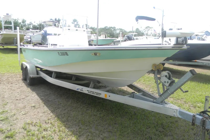 Slide: The Image of 2016 Frontier 2104 boat on trailer, parked on grass. - 7