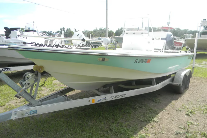 Slide: The Image of 2016 Frontier 2104 boat on trailer, parked outdoors, side view. - 9