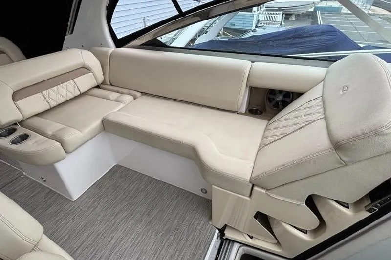 Slide: The Image of Luxurious interior seating of a 2019 Regal 33 XO boat with beige upholstery. - 10