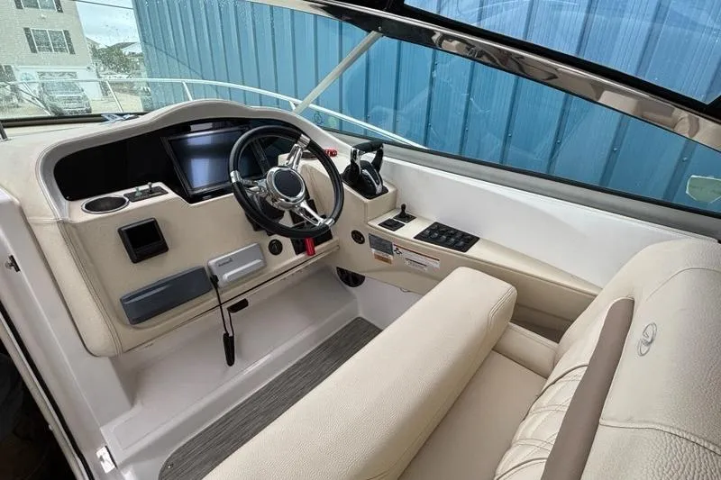 Slide: The Image of 2019 Regal 33 XO boat cockpit with steering wheel and control panel. - 5