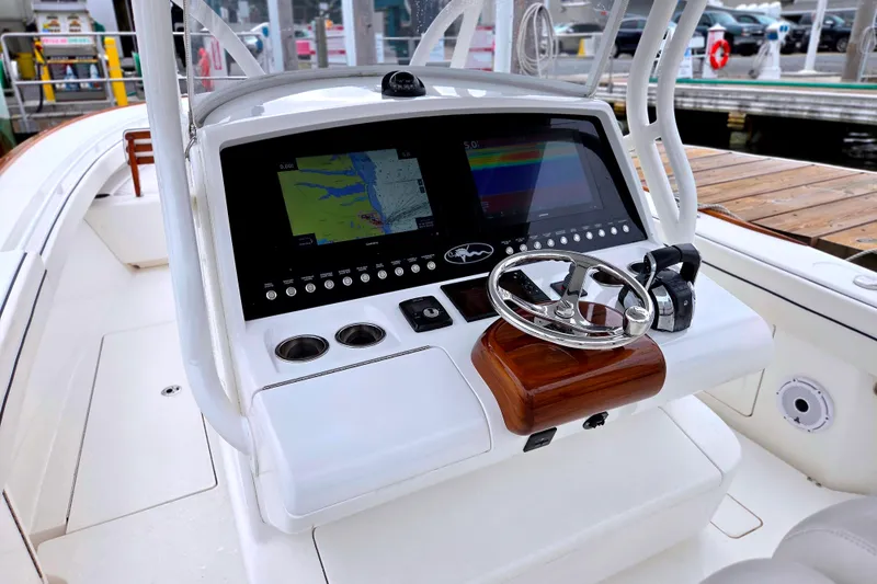 Slide: The Image of 2021 Valhalla Boatworks V-33 helm with navigation screens and steering wheel. - 13