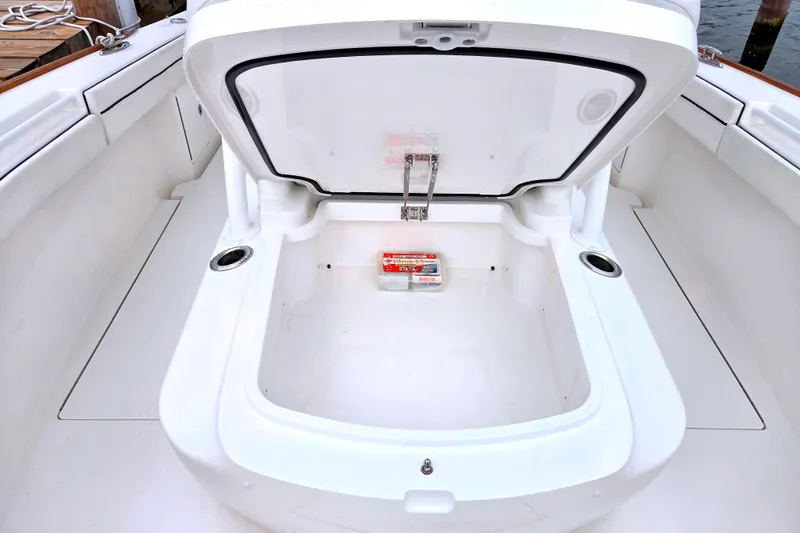 Slide: The Image of 2021 Valhalla Boatworks V-33 storage compartment open, showcasing spacious interior design. - 16