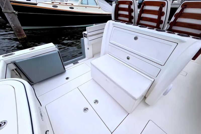Slide: The Image of 2021 Valhalla Boatworks V-33 interior with seating and storage, docked near water. - 18