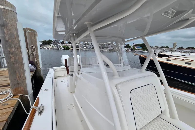 Slide: The Image of 2021 Valhalla Boatworks V-33 docked, showcasing sleek design and spacious seating. - 19