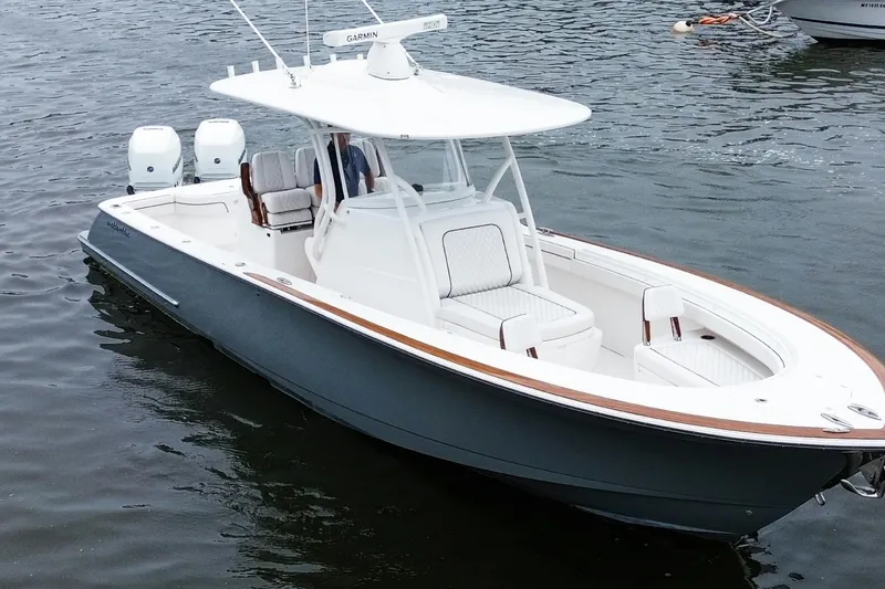 Slide: The Image of 2021 Valhalla Boatworks V-33 on water, featuring sleek design and dual engines. - 2