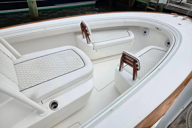 Slide: The Image of 2021 Valhalla Boatworks V-33 interior with white quilted seating and wooden accents. - 3