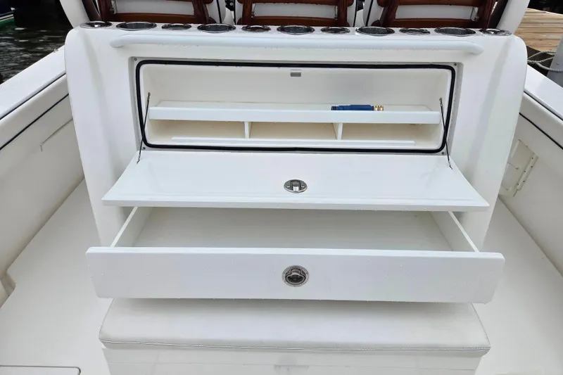 Slide: The Image of 2021 Valhalla Boatworks V-33 interior storage compartments with open drawers and shelves. - 9