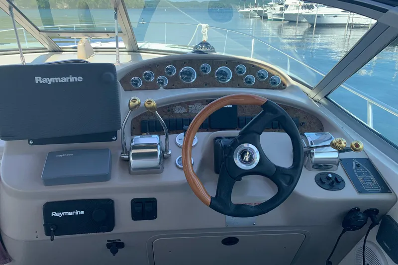 Slide: The Image of Cockpit of 2001 Sea Ray 340 Sundancer with Raymarine navigation system and wooden steering wheel. - 10