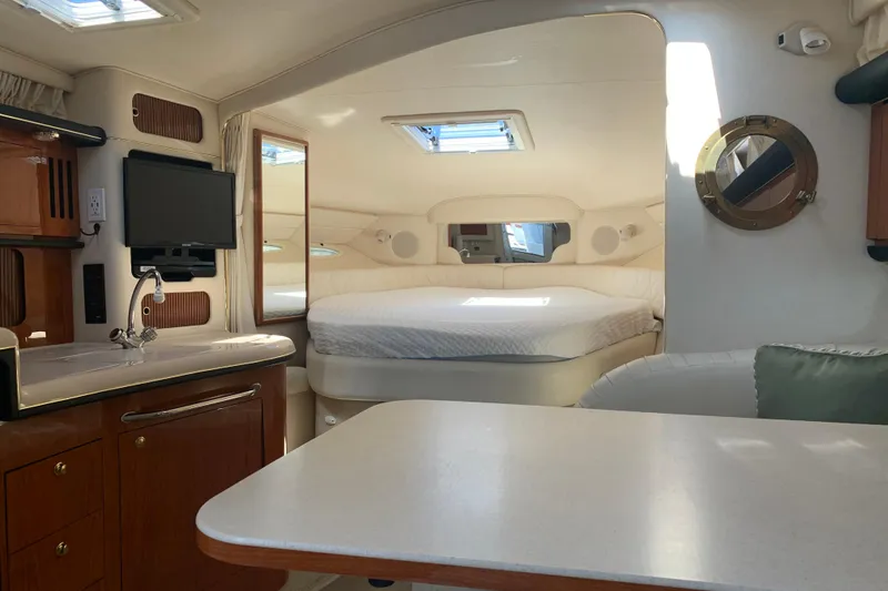 Slide: The Image of Interior of 2001 Sea Ray 340 Sundancer yacht with bed, kitchenette, and seating area. - 14