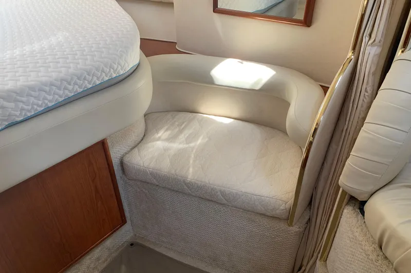 Slide: The Image of Interior of 2001 Sea Ray 340 Sundancer with cushioned seating and bed. - 16