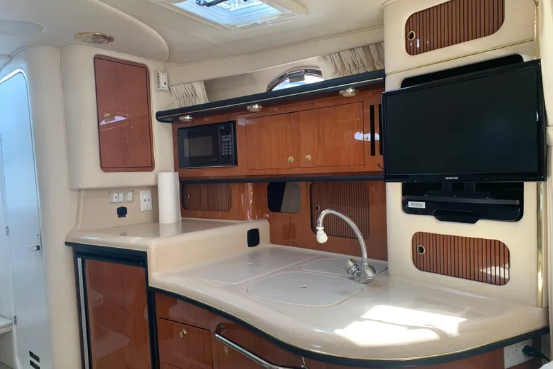 Slide: The Image of Interior of 2001 Sea Ray 340 Sundancer yacht with kitchenette and TV. - 17