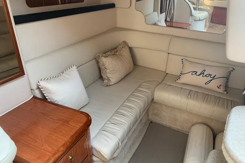 Slide: The Image of Interior of 2001 Sea Ray 340 Sundancer with cozy seating and nautical decor. - 21
