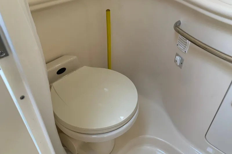 Slide: The Image of 2001 Sea Ray 340 Sundancer boat bathroom with toilet and safety rail. - 24
