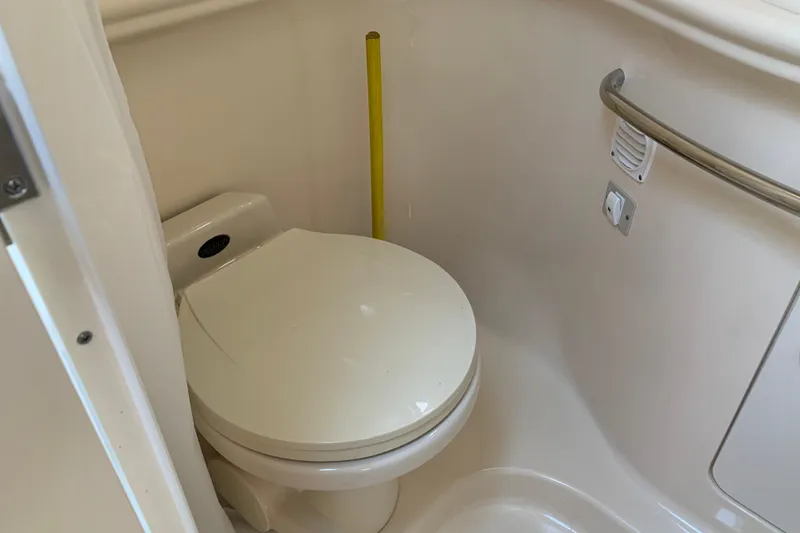 Slide: The Image of 2001 Sea Ray 340 Sundancer boat bathroom with toilet and safety rail. - 25