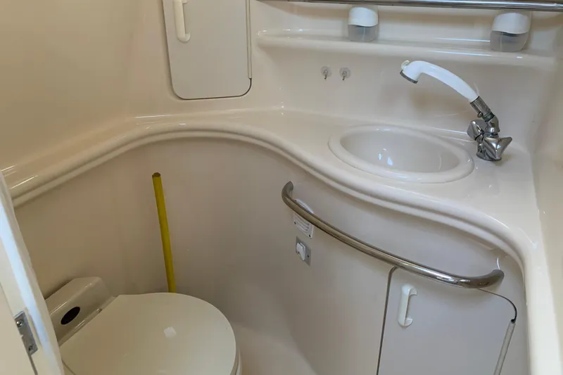 Slide: The Image of 2001 Sea Ray 340 Sundancer bathroom with sink, faucet, and toilet. - 26
