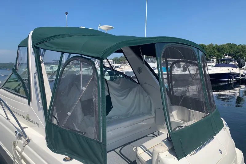 Slide: The Image of 2001 Sea Ray 340 Sundancer with green canopy docked at marina. - 29