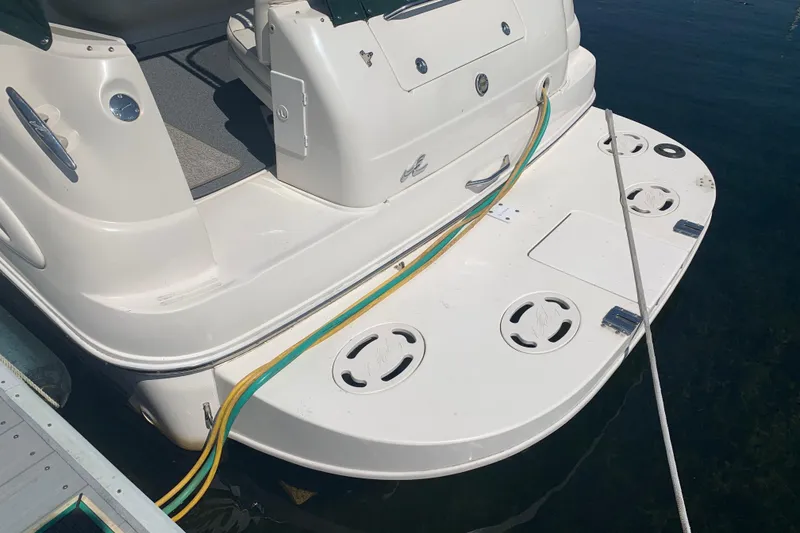 Slide: The Image of 2001 Sea Ray 340 Sundancer boat stern with swim platform and docked cables. - 3