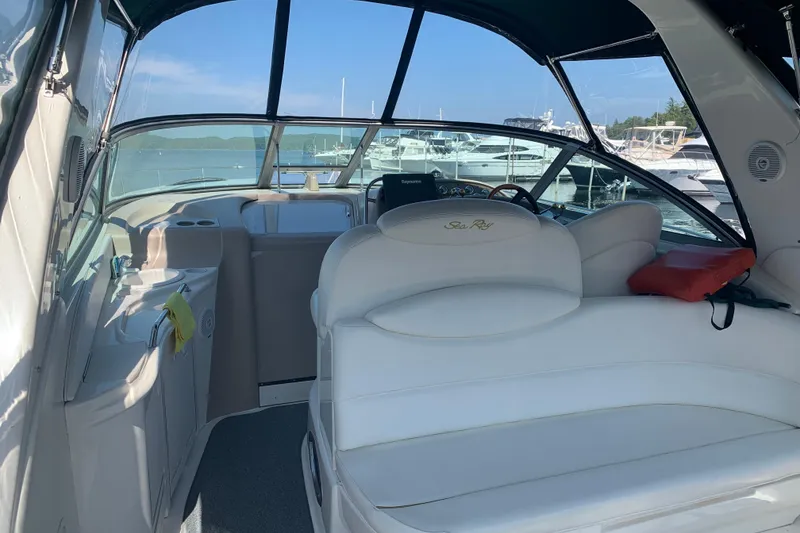 Slide: The Image of Interior of a 2001 Sea Ray 340 Sundancer yacht with white seating and marina view. - 4