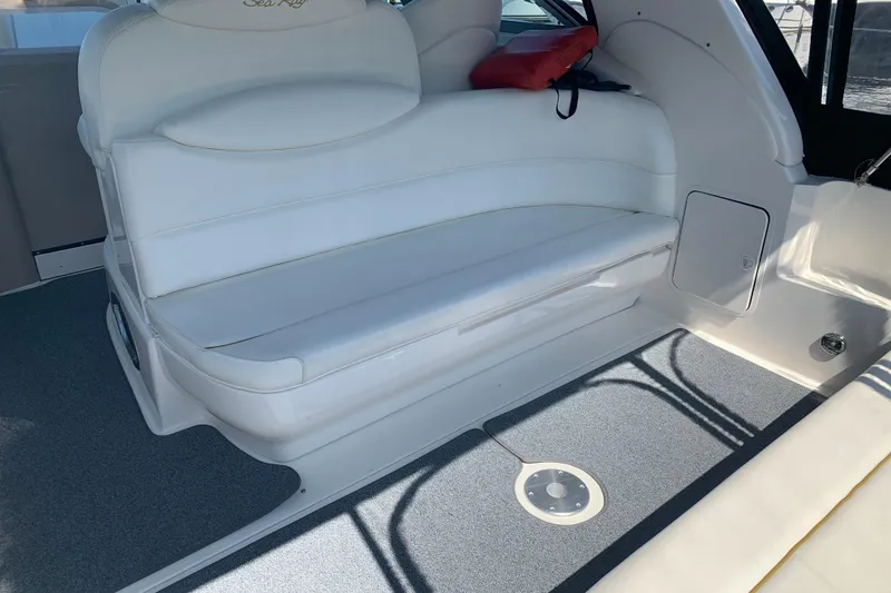 Slide: The Image of 2001 Sea Ray 340 Sundancer interior with white seating and gray flooring. - 5