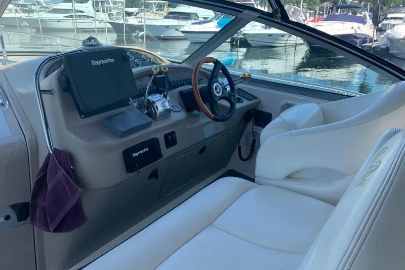 Slide: The Image of 2001 Sea Ray 340 Sundancer helm with Raymarine equipment, docked at marina. - 7
