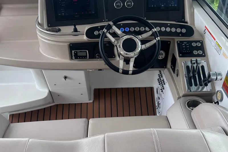 Slide: The Image of 2008 Formula 400 Super Sport boat on trailer, parked near a lake under a blue sky. - 4