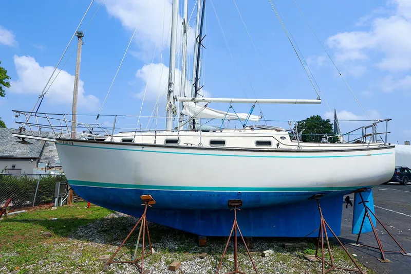 The Image of 1985 Island Packed 31 yacht on stands, blue sky background. - 0