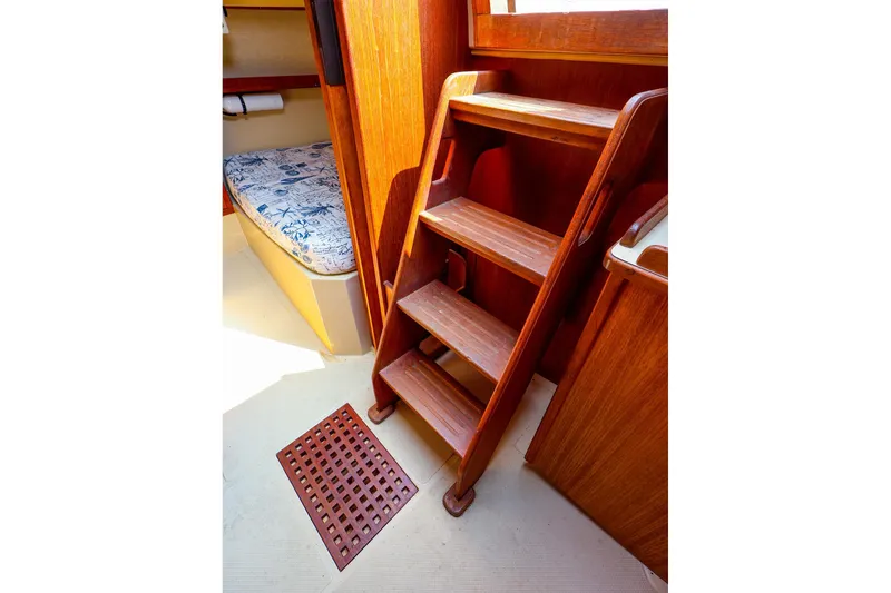 Slide: The Image of Interior of 1985 Island Packed 31 yacht with wooden steps and cozy cabin. - 13