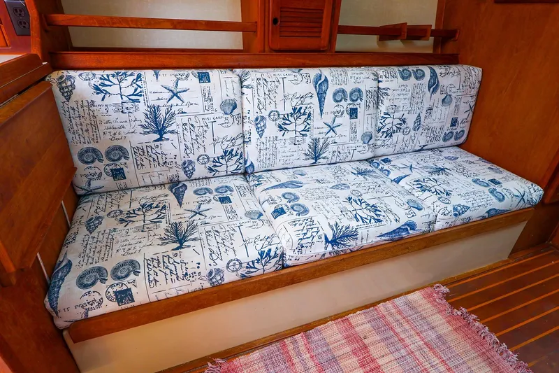 Slide: The Image of 1985 Island Packed 31 yacht interior with nautical-themed cushioned seating. - 16