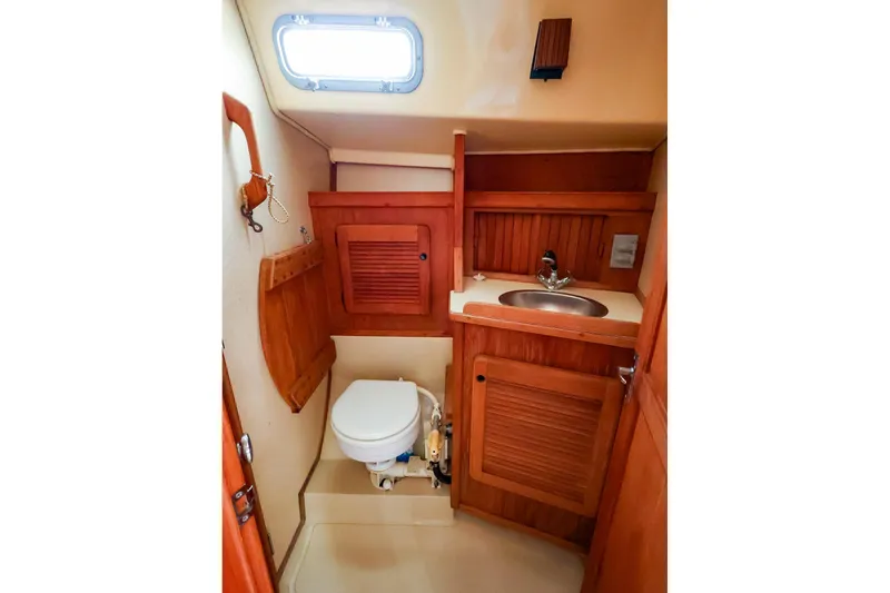 Slide: The Image of 1985 Island Packed 31 yacht bathroom with wooden cabinetry and compact design. - 27