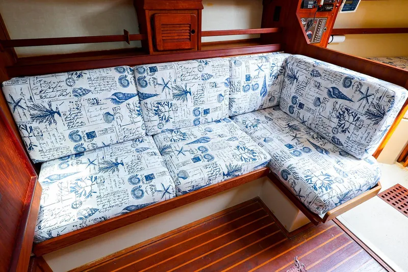 Slide: The Image of 1985 Island Packed 31 yacht interior with nautical-themed cushioned seating. - 17