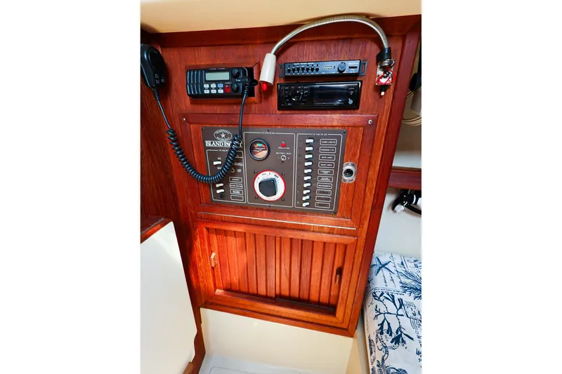 Slide: The Image of Control panel of 1985 Island Packed 31 yacht with radio and switches. - 23