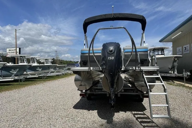 Slide: The Image of 2025 Bennington 22M pontoon boat with 150 HP engine, displayed outdoors. - 4